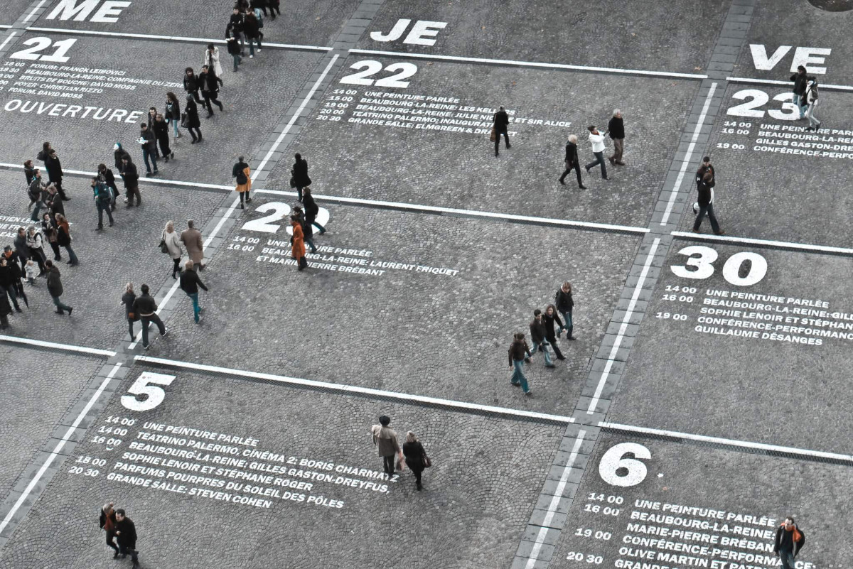 People walking on a calendar-designed square from above